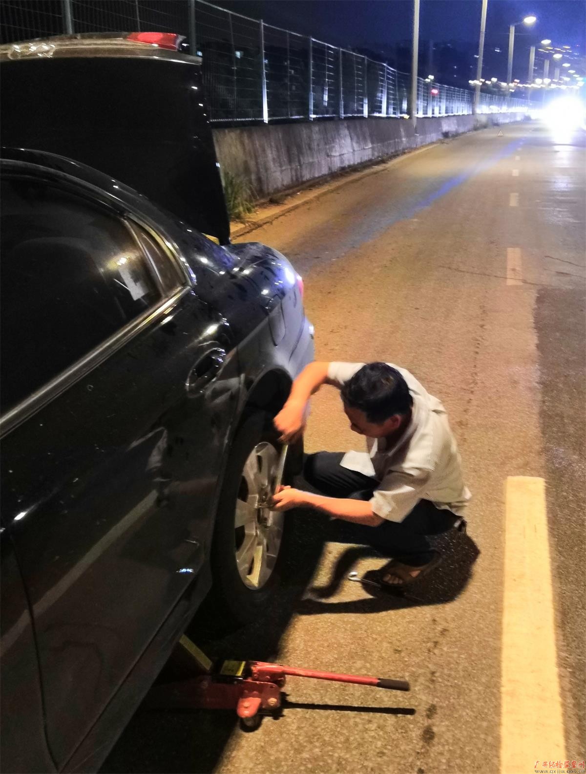 下乡回来途中,聂桂强在换轮胎